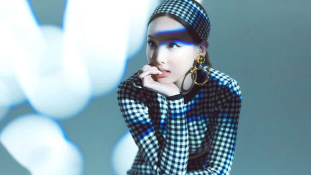 A portrait of Nayeon in a checkered dress and headband with dramatic lighting effects, 4K Desktop Wallpaper