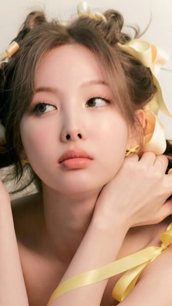 Nayeon Wallpapers showing a close up portrait with delicate yellow ribbons in her hair, HD Mobile Wallpaper