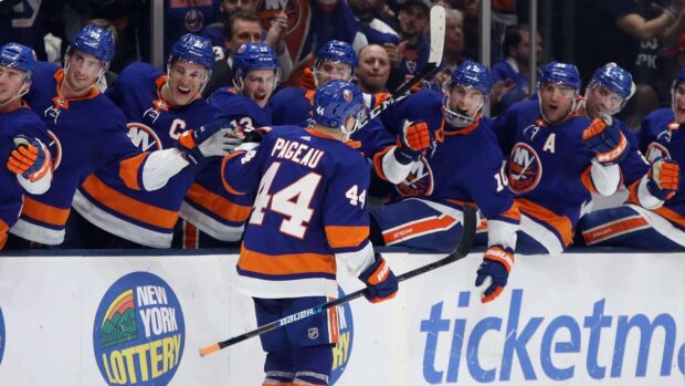 The New York Islanders players celebrate a goal during a hockey game, HD Desktop Wallpaper