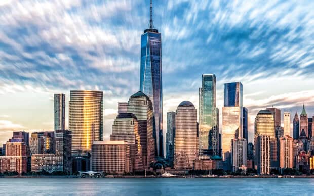 The New York skyline shows tall buildings reflecting the evening light, 2K Desktop Wallpaper