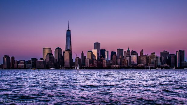 The New York skyline is illuminated at sunset behind the water, HD Desktop Wallpaper
