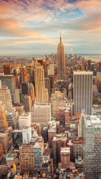 The New York skyline showcases iconic skyscrapers under a colorful sky, 2K Mobile Wallpaper