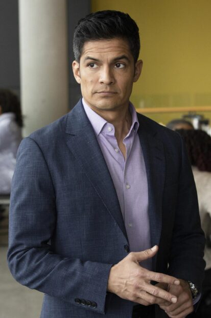 Nicholas Gonzalez in a navy blazer and light purple shirt standing indoors, 2K Mobile Wallpaper