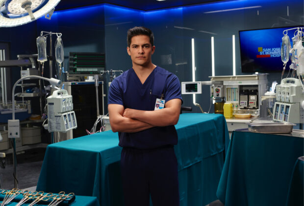 Nicholas Gonzalez standing with arms crossed in a modern hospital room, HD Desktop Wallpaper