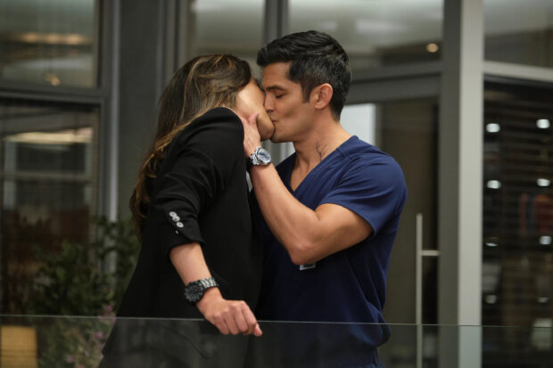 Nicholas Gonzalez kissing a woman in a tender moment indoors, 2K Desktop Wallpaper