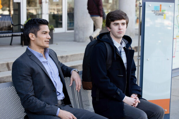 Nicholas Gonzalez sitting outdoors with a friend at a bus stop, 2K Desktop Wallpaper