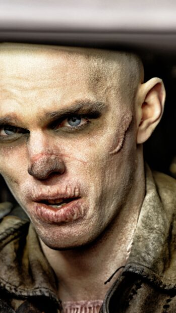 A close up of Nicholas Hoult showing detailed scars on his face and intense eyes, 2K Mobile Wallpaper