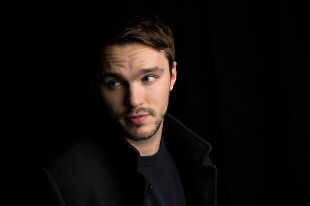 A close up of Nicholas Hoult looking sideways with a dark background, HD Desktop Wallpaper