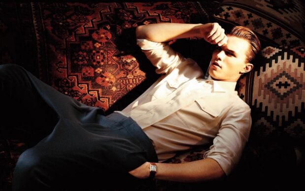 Nicholas Hoult wallpapers show him lying on a richly textured sofa with intricate designs, HD Desktop Wallpaper