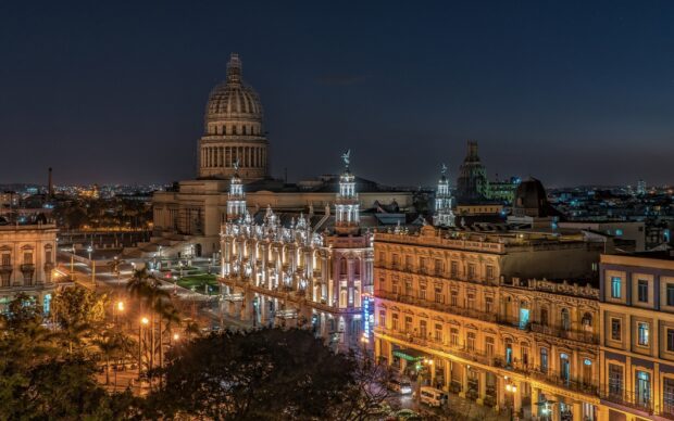 The night scene of Havana Cuba shows illuminated historic buildings and city lights, HD Desktop Wallpaper