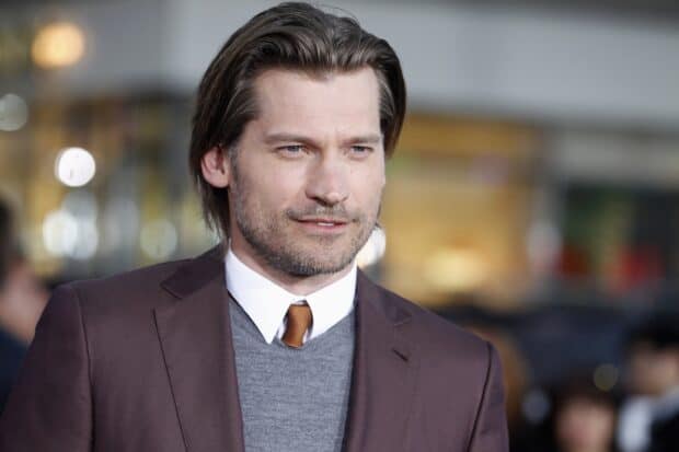 A close up portrait of Nikolaj Coster Waldau wearing a suit and tie with a thoughtful expression, 2K Desktop Wallpaper