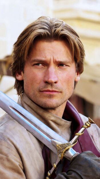 Nikolaj Coster Waldau looks serious holding an ornate sword in a medieval outfit, HD Phone Wallpaper