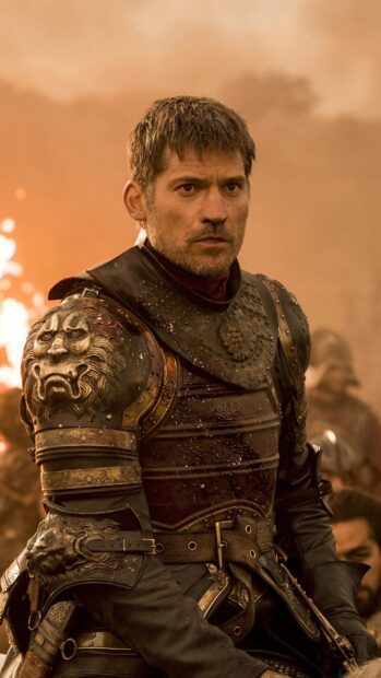 Nikolaj Coster Waldau wears detailed armor during a battle scene with a fiery background, HD Phone Wallpaper