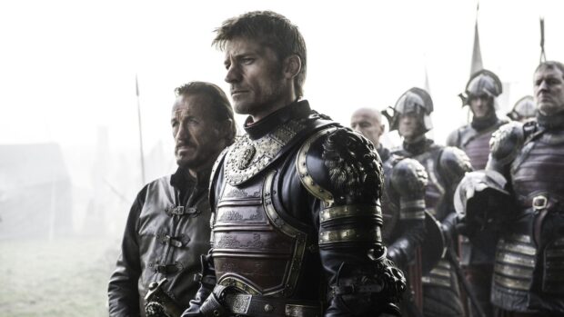 Nikolaj Coster Waldau stands confidently in detailed armor surrounded by soldiers in a misty battlefield, HD Desktop Wallpaper