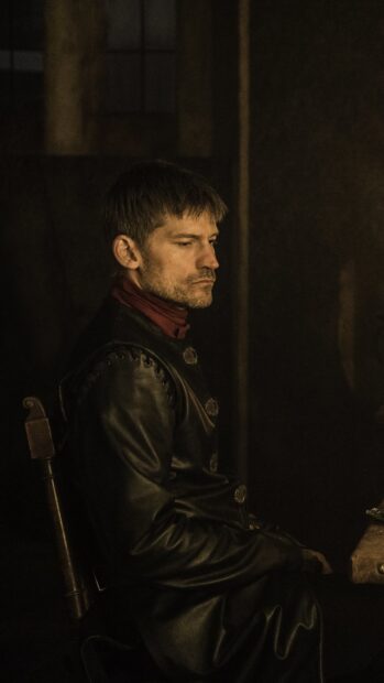 Nikolaj Coster Waldau sits thoughtfully in a dark room wearing a leather costume, HD Phone Wallpaper