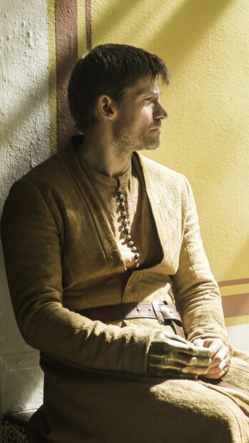 Nikolaj Coster Waldau sits pensively in a medieval outfit with a golden glove, HD Mobile Wallpaper