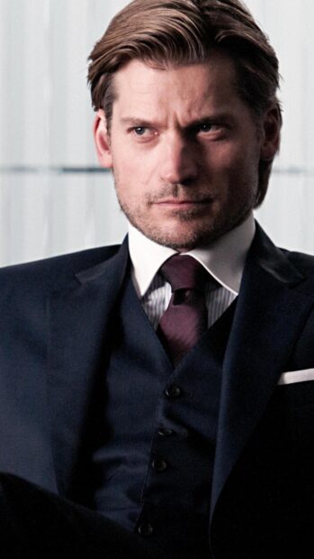 Nikolaj Coster Waldau looks serious in a dark suit with a maroon tie, 2K Mobile Wallpaper