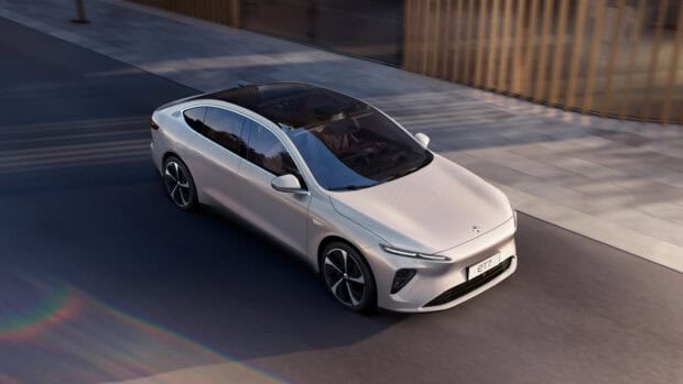 A Nio Auto is seen driving smoothly on a city street during daytime, HD Desktop Wallpaper