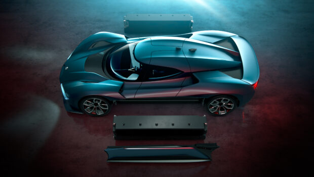 A sleek blue Nio Auto is displayed from above with car components on a dark surface, 4K Desktop Wallpaper