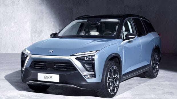 A blue Nio Auto ES8 electric SUV is displayed in a studio setting, HD Desktop Wallpaper