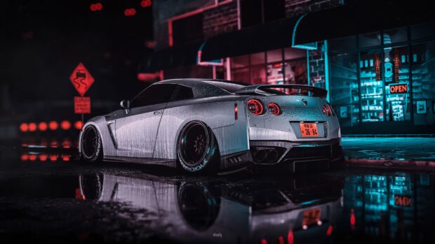 A silver Nissan GT R is parked near a neon lit building reflecting on the wet pavement at night, 4K Desktop Wallpaper