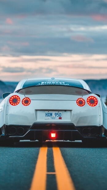 The Nissan GT R is captured from the rear on a road at dusk, HD Mobile Wallpaper