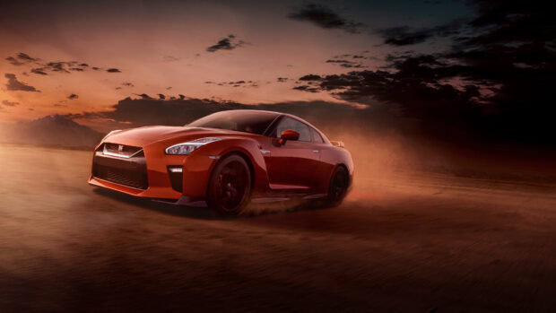 A Nissan GT R is driving fast on a dusty desert road at sunset, 4K Desktop Wallpaper