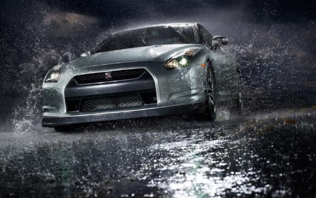 A silver Nissan GT R is driving fast under heavy rain at night, 2K Desktop Wallpaper