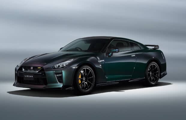 A dark green Nissan GT R is shown in a studio setting highlighting its sleek design, HD Desktop Wallpaper