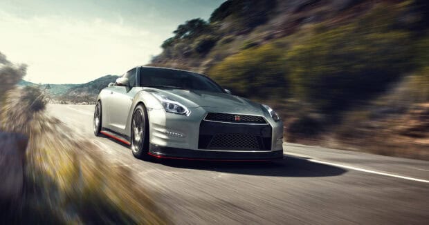 A Nissan GT R is driving fast on a winding road with blurred background, 4K Desktop Wallpaper