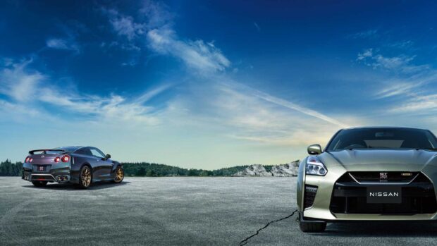 Two Nissan GT R cars parked with clear sky background, HD Desktop Wallpaper