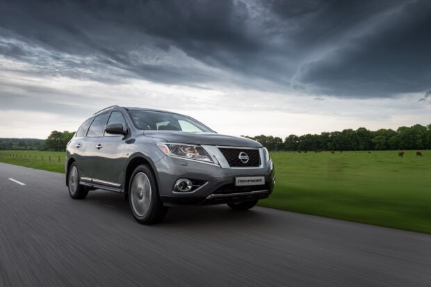 A gray Nissan Pathfinder drives on a rural road with cloudy skies, 2K Desktop Wallpaper