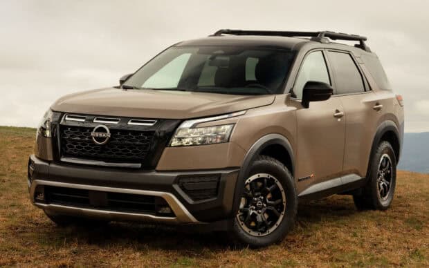 A Nissan Pathfinder is parked on a grassy field under a cloudy sky, HD Desktop Wallpaper