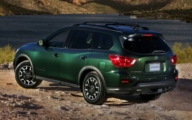 A green Nissan Pathfinder parked near a lake with mountains in the background, HD Desktop Wallpaper