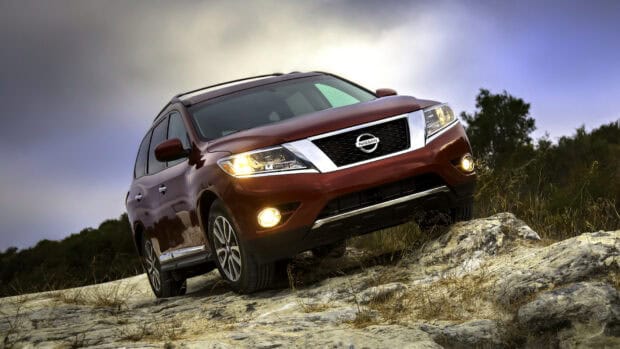 A Nissan Pathfinder drives over rocky terrain during an off road adventure, HD Desktop Wallpaper