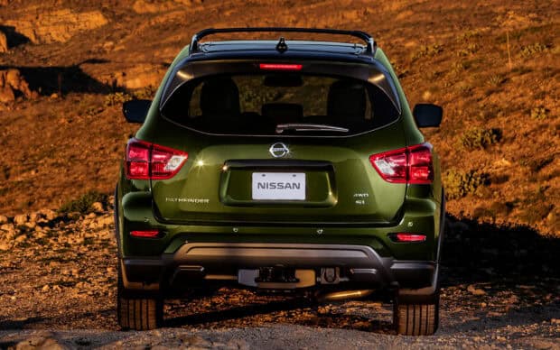 The Nissan Pathfinder is shown from the back with a rugged outdoor setting, HD Desktop Wallpaper