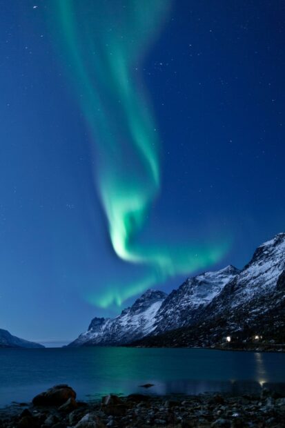 The northern lights glow brightly over snowy Norwegian mountains and calm waters under a starry sky, HD Mobile Wallpaper