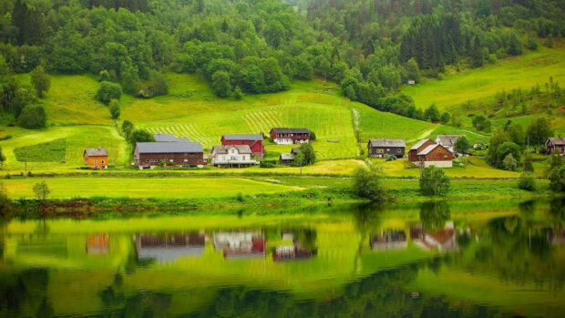 A peaceful Norway landscape with houses and green hills reflecting in the calm lake, HD Desktop Wallpaper