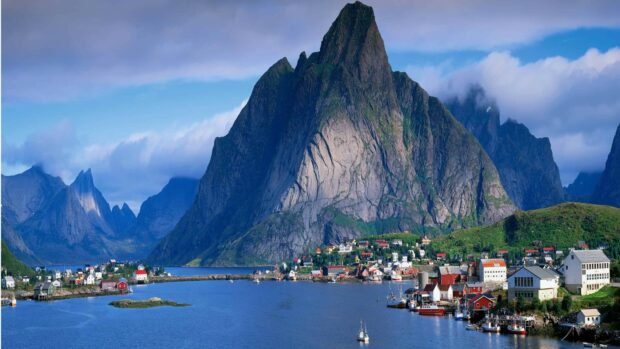 A scenic view of a Norway village by the water with towering mountains in the background, 4K Desktop Wallpaper