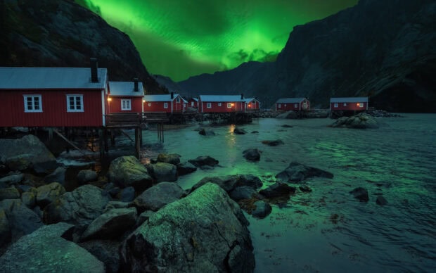 Red cabins by the fjord under the glowing northern lights in Norwegian fjords, HD Desktop Wallpaper