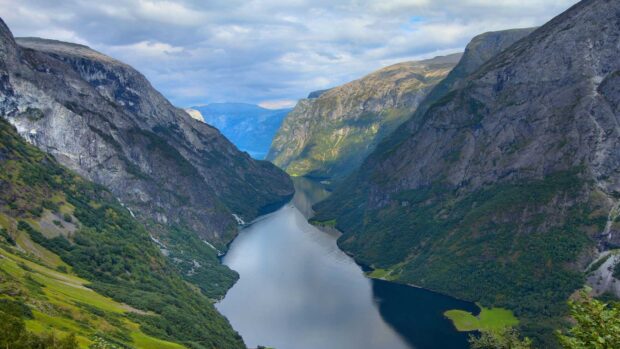 A breathtaking view of Norwegian fjords with steep cliffs and calm water, HD Desktop Wallpaper