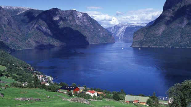 A scenic view of Norwegian fjords with calm water and mountains, 2K Desktop Wallpaper