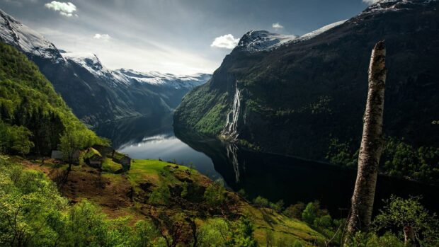 A scenic view of Norwegian fjords with waterfalls and green mountains under a cloudy sky, HD Desktop Wallpaper