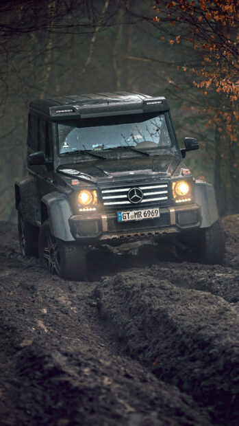 A black off road vehicle driving through deep muddy terrain in a forest, 4K Mobile Wallpaper