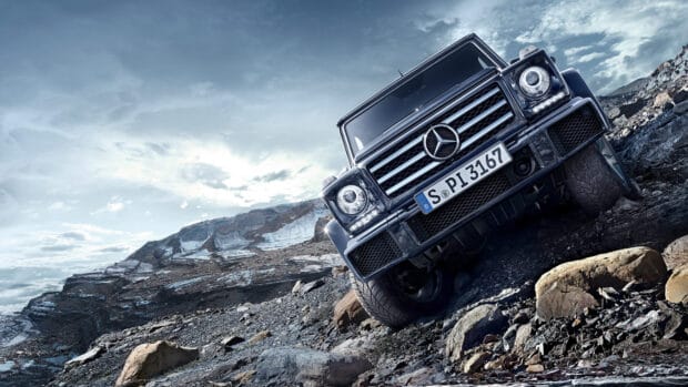 A black Mercedes SUV tackles rough off road driving in mountainous terrain, 4K Desktop Wallpaper