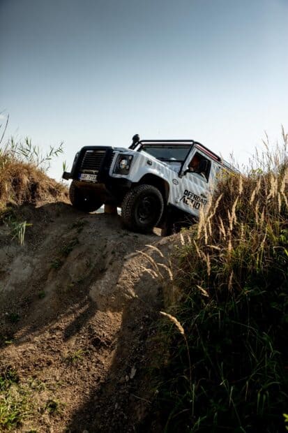 A vehicle is climbing a steep hill while off road driving through rough terrain under a clear sky, HD Mobile Wallpaper