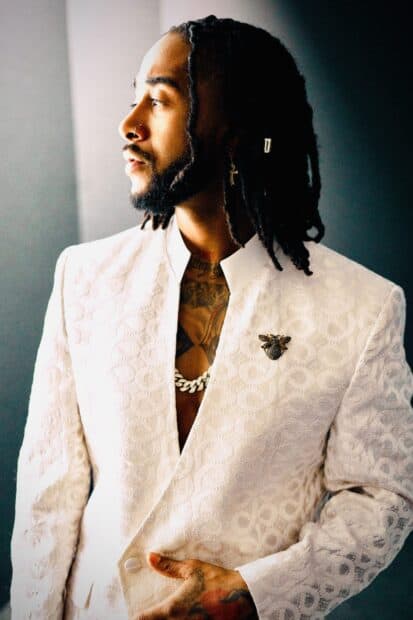 A man wearing a white textured suit stands against a gray background in Omarion Wallpapers, 2K Mobile Wallpaper