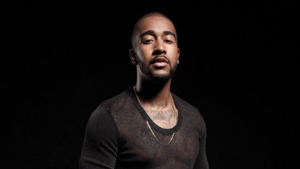Omarion wallpapers features a confident man wearing a black shirt and gold chain, HD Desktop Wallpaper