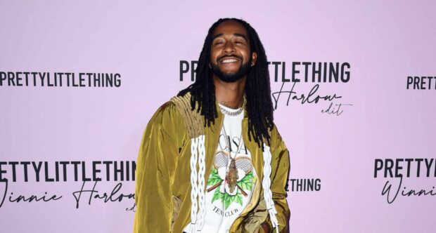 Omarion is smiling confidently wearing a stylish jacket and jewelry at an event, HD Desktop Wallpaper