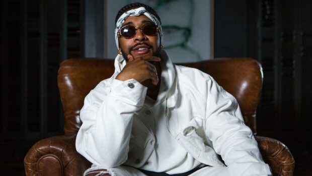 Omarion is sitting confidently in a white outfit and sunglasses, HD Desktop Wallpaper